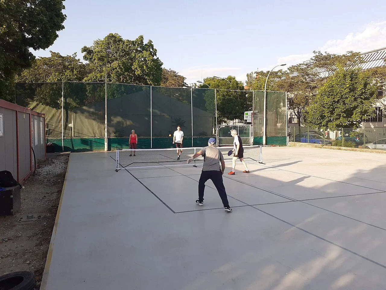 Players at the net during a doubles pickleball game