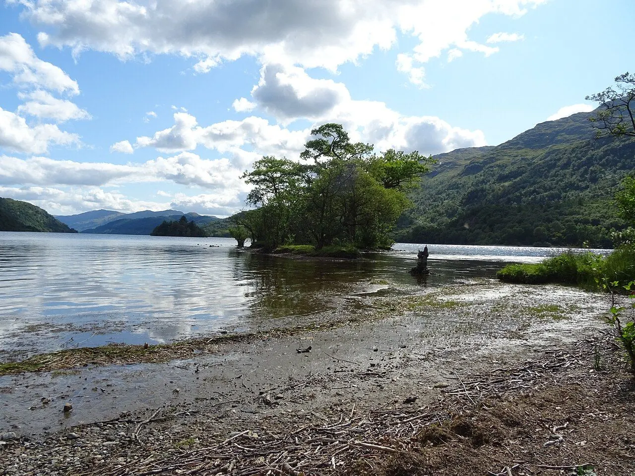 Tent pitched on open moorland beside a Scottish loch